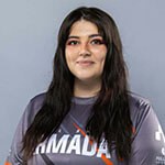 Brittanny MacCleod stands against a gray background and smiles. She has long brown hair and is wearing a gray Armada jersey.